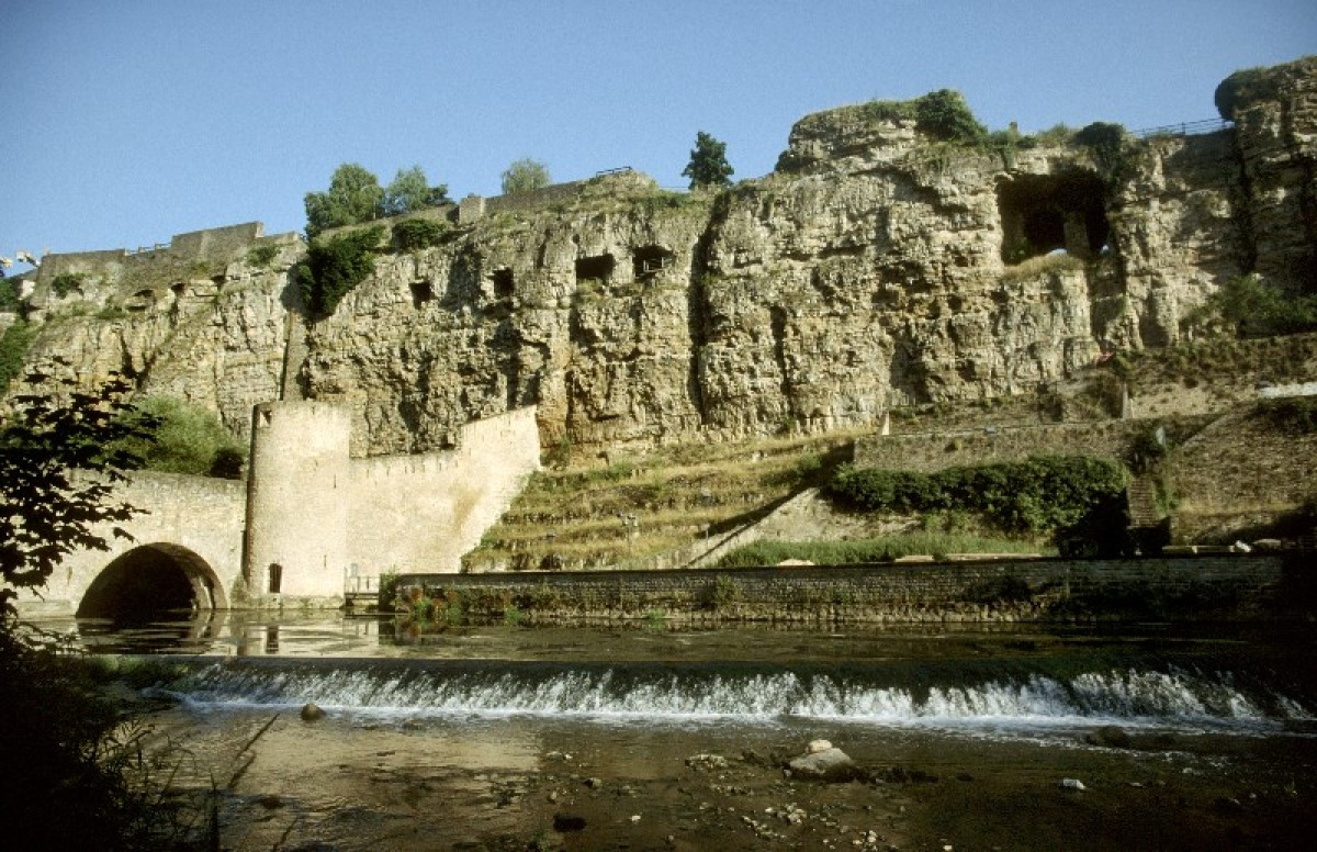 The Alzette River in Luxembourg City with the Bock Casemates in the background, UNESCO-listed fortifications that are a key part of the city's history.